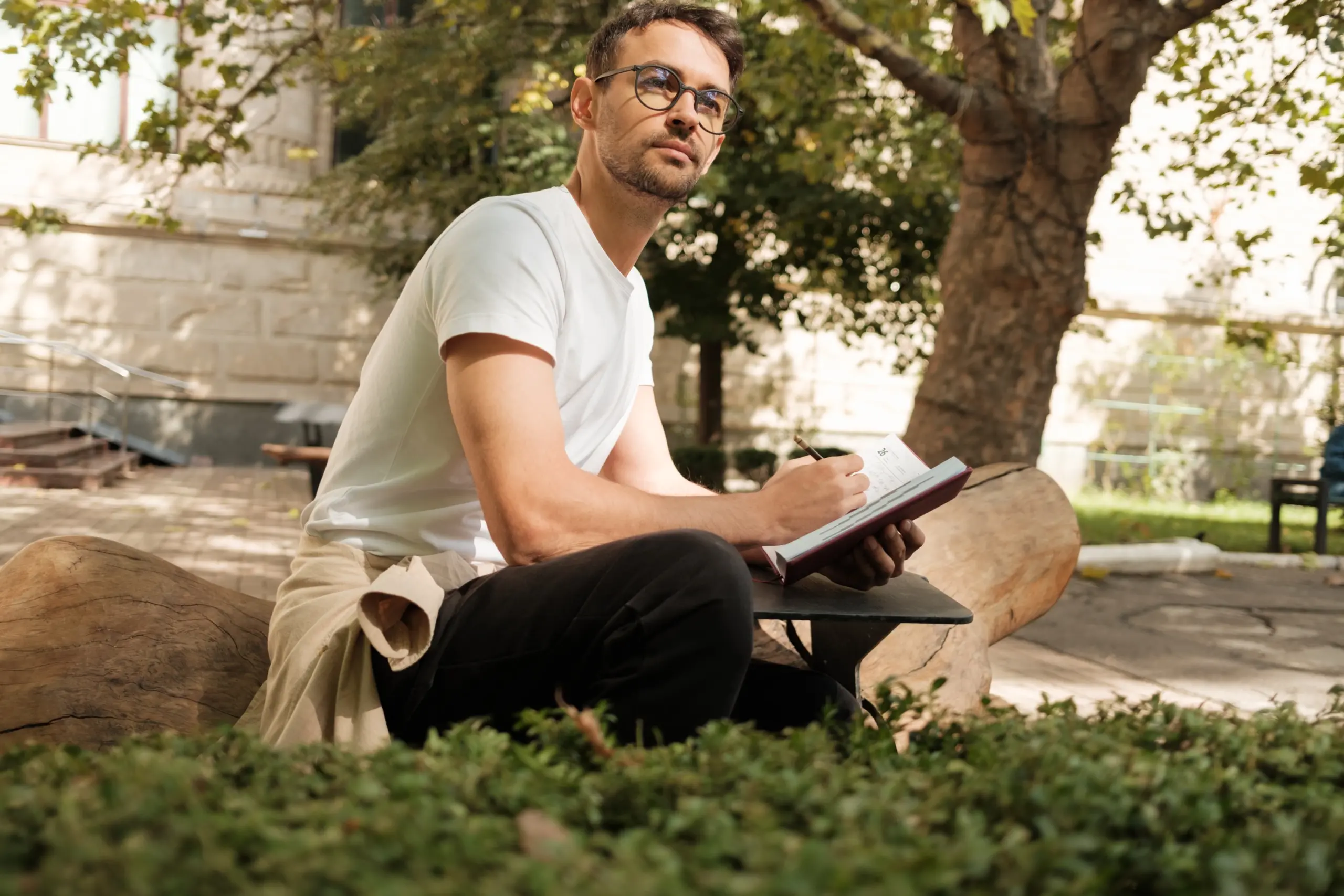 individual writing in a recovery journal during a relapse prevention session
