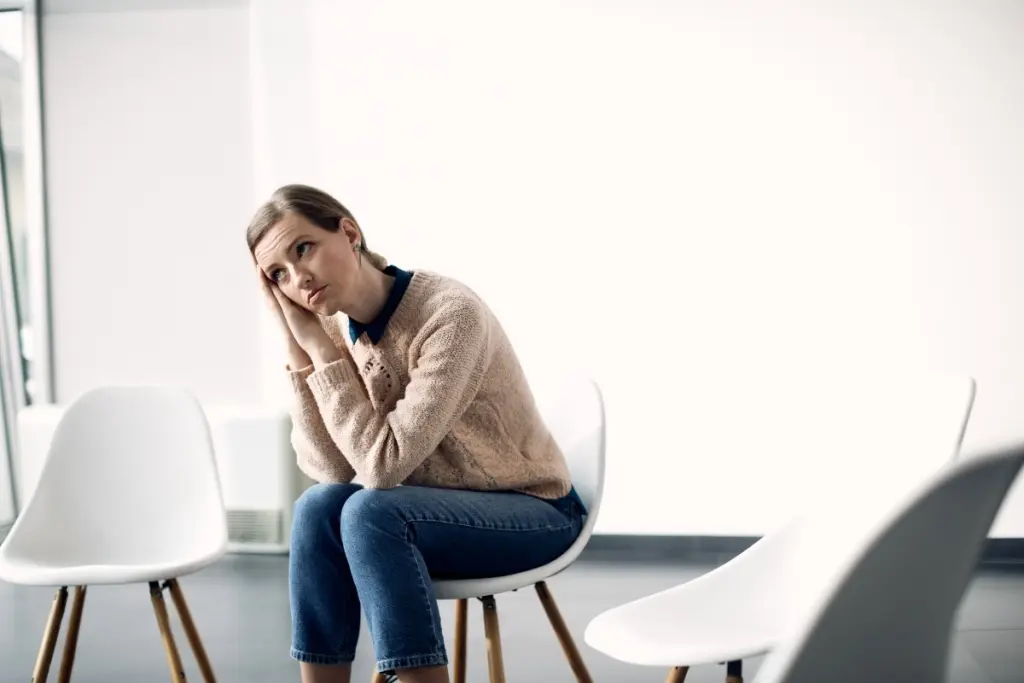 Girl waiting for a group therapy session for addicts.