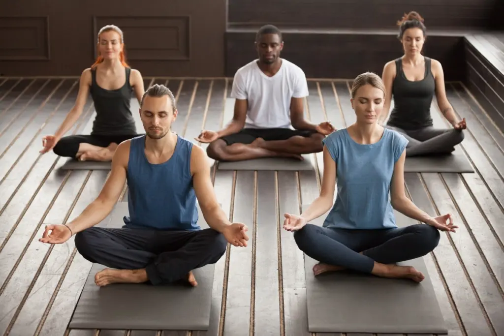 People practising meditation in a luxury rehab center.