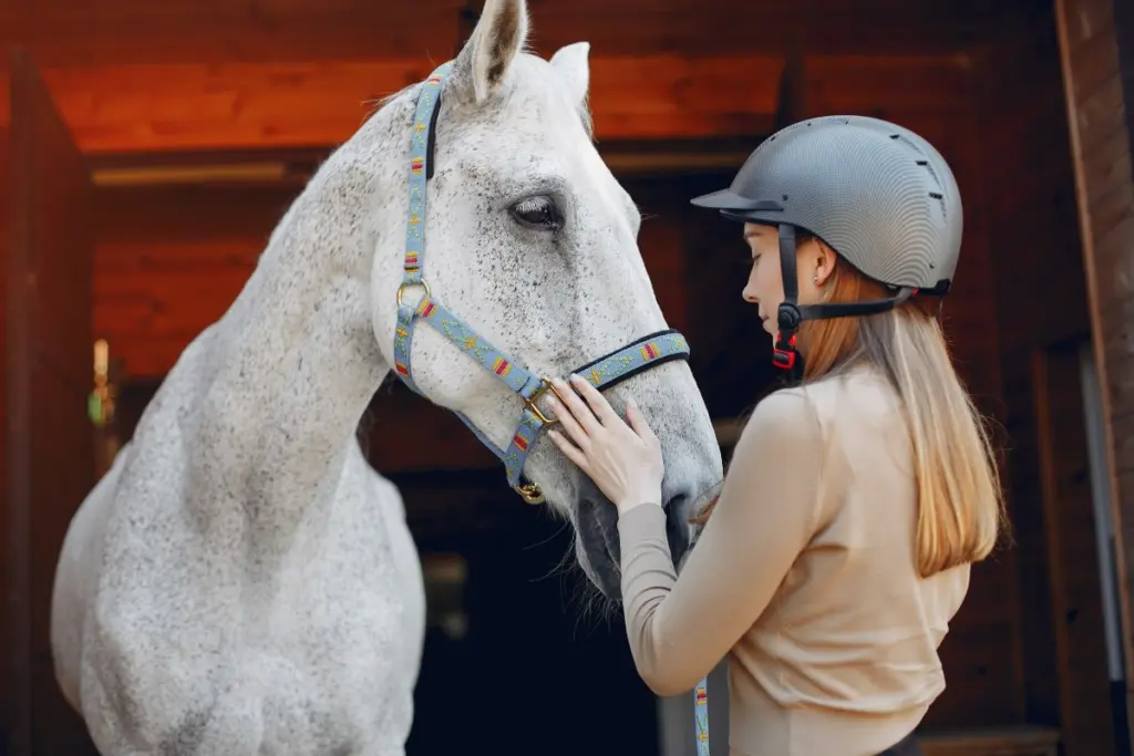 Young woman practising equine-assisted therapy.