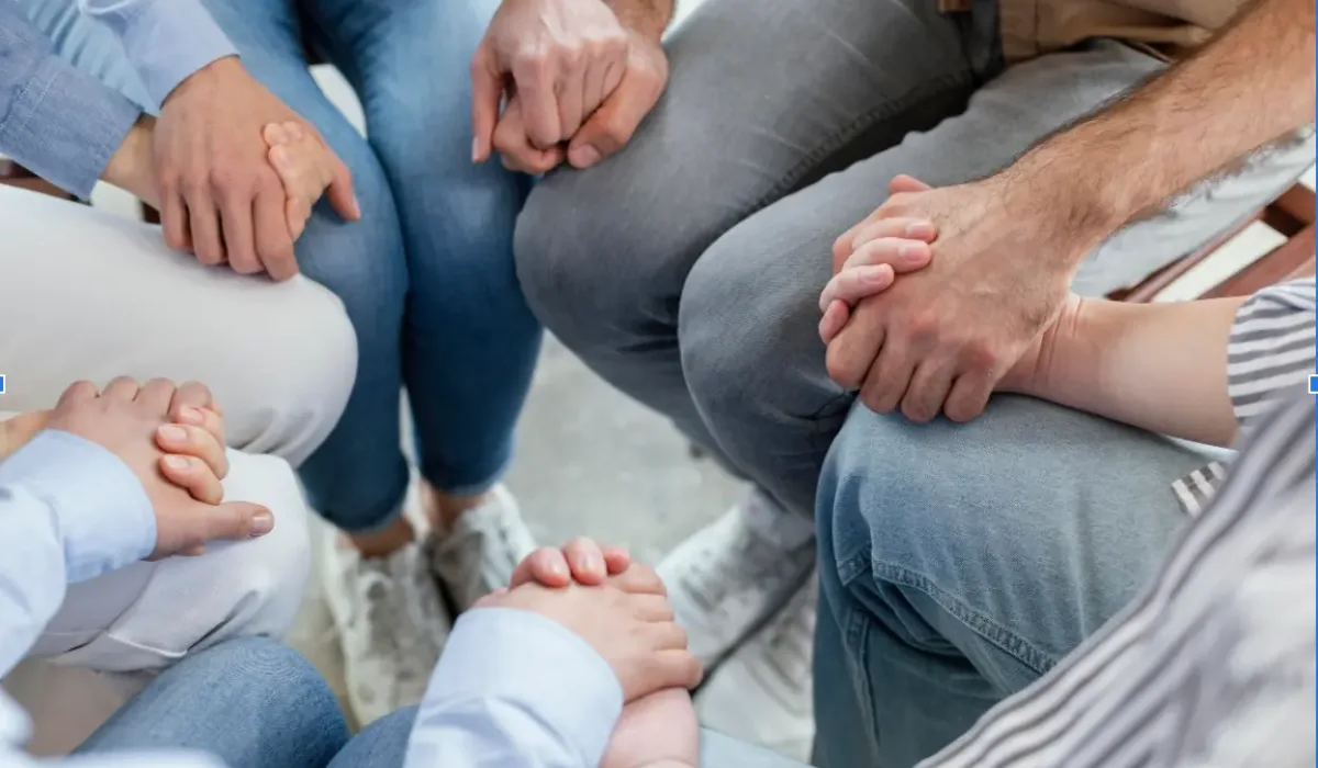 Holding hands to show family support during addiction recovery.