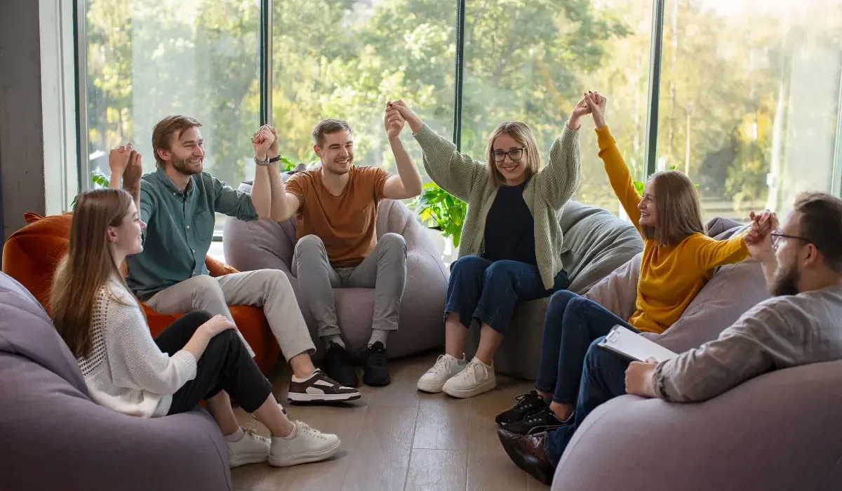 People holding hands and giving each other support for relapse prevention.